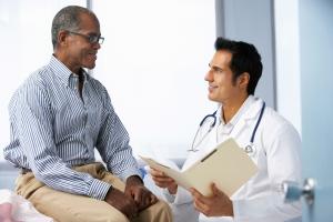 A man consults with a Summit Health doctor during a pain management appointment, discussing treatment options for chronic pain relief